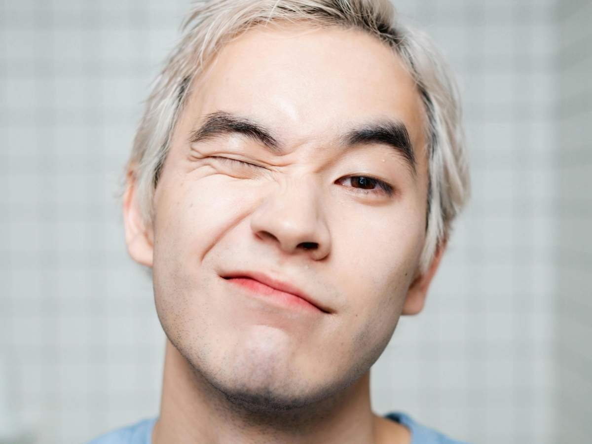 Young Filipino man with a playful expression, representing discussions on premature ejaculation and its common causes among Filipino men.